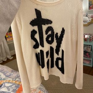 Wooden ships sweater that says “Stay Wild”